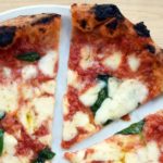 How do Italians eat pizza?