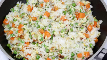 How do you add flavor to cooked rice?