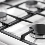 How do you clean a gas burner with vinegar?