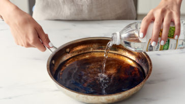 How do you clean the bottom of a stainless steel pan?