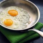 How do you fry eggs in a stainless steel pan?