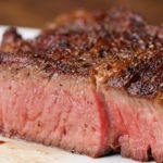 How do you grill a 2 inch thick ribeye steak?