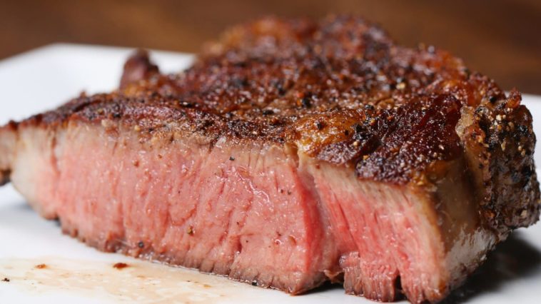 How do you grill a 2 inch thick ribeye steak?