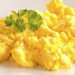 How do you make scrambled eggs taste better?