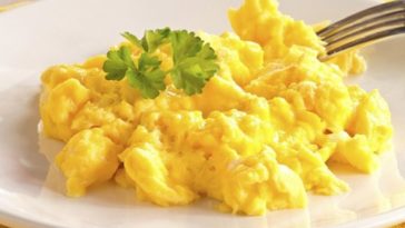How do you make scrambled eggs taste better?