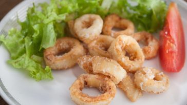How do you tenderize calamari before frying?