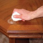 How does toothpaste remove heat marks from wood?