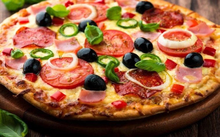 How is pizza eaten in Italy?