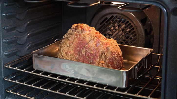 How long do you cook a precooked ham in a roaster?