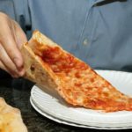 How many calories does a slice of Toppers pizza have?