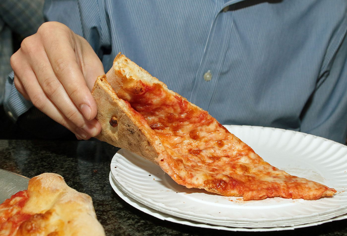 How many calories does a slice of Toppers pizza have?