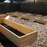 Should I put rocks in the bottom of my raised garden bed?