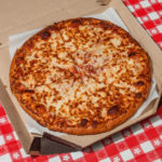 What does Dominos cook their pizza on?