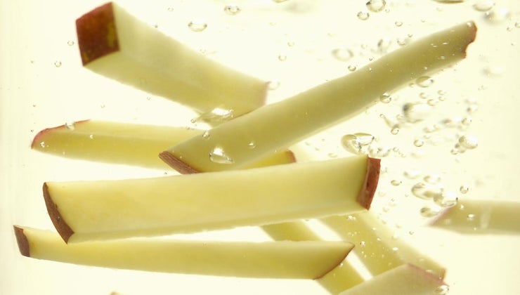 What does soaking potatoes in water do?