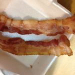 What happens if bacon is undercooked?