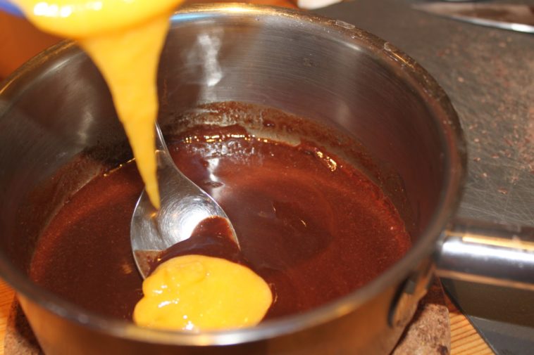 What happens if you add butter to melted chocolate?