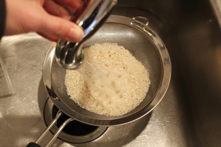 What is the benefit of rinsing rice?