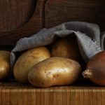 What is the best way to store potatoes onions and garlic?