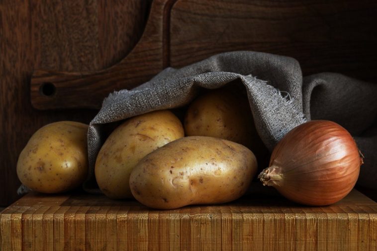 What is the best way to store potatoes onions and garlic?