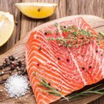 Where is farm-raised salmon banned?