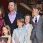 Why are Caroline and her husband so happy over Scrooge's death?