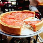 Why is the sauce on top of deep-dish pizza?
