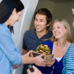 What is a customary gift to bring on a visit to someone's home?
