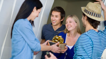 What is a customary gift to bring on a visit to someone's home?