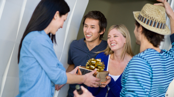 What is a customary gift to bring on a visit to someone's home?