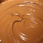 Can you add milk to melted chocolate to thin it out?