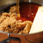 What does adding butter to caramel do?