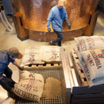 Who does Starbucks buy coffee beans from?