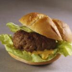 Do I need to defrost frozen burgers before grilling?