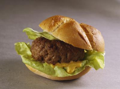 Do I need to defrost frozen burgers before grilling?