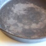 Do you need to grease cast iron before baking?