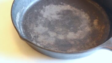 Do you need to grease cast iron before baking?