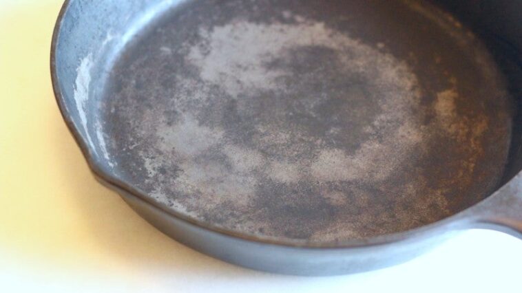 Do you need to grease cast iron before baking?
