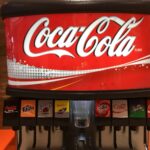 How do you refill a Coke machine?