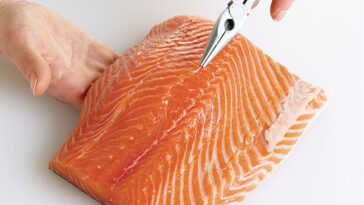 How do you remove bones from fish before cooking?