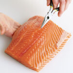 How do you remove bones from fish before cooking?