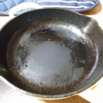 How do you remove burnt food from a cast iron pan?