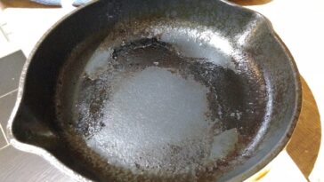 How do you remove burnt food from a cast iron pan?