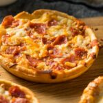 Should I thaw a frozen pizza before baking?