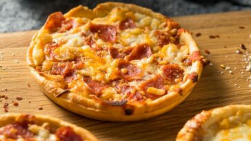 Should I thaw a frozen pizza before baking?