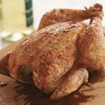 Should whole chicken be cooked breast-side up or down?
