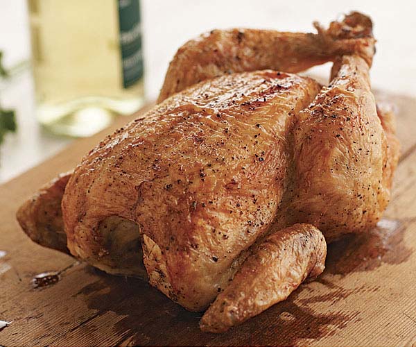 Should whole chicken be cooked breast-side up or down?