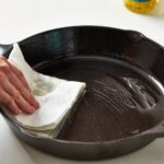 What happens if you wash a cast iron skillet with soap?