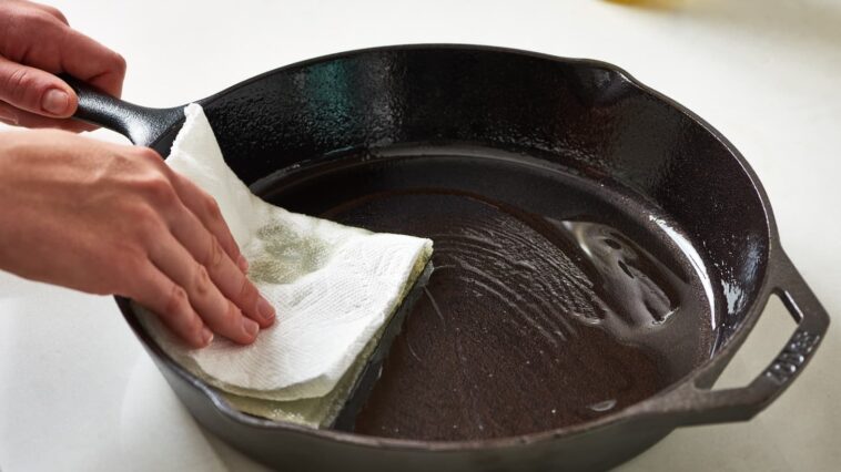 What happens if you wash a cast iron skillet with soap?