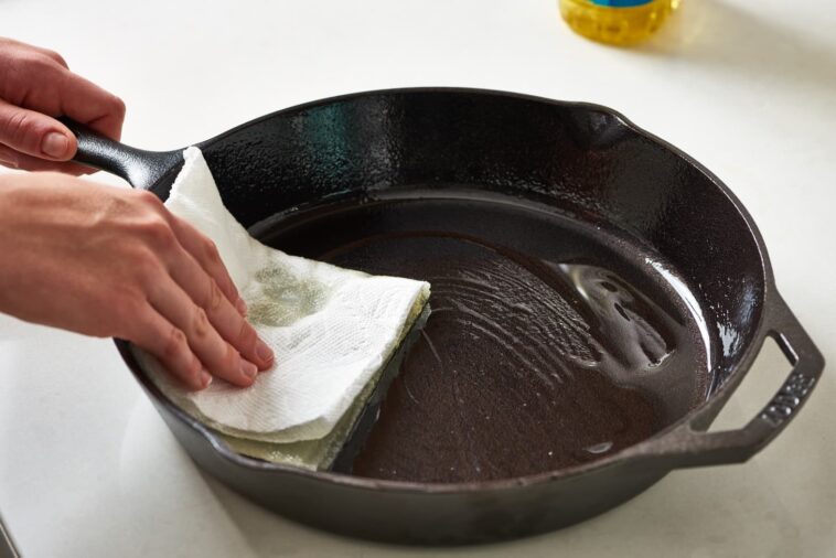 What happens if you wash a cast iron skillet with soap?