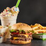 When did BurgerFi start franchising?